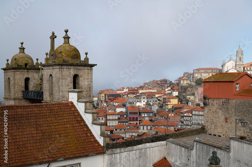 View to the historical center of the city of Porto. São Lourenço church and Rua das Aldas viewpoint. Foggy morning. photo
