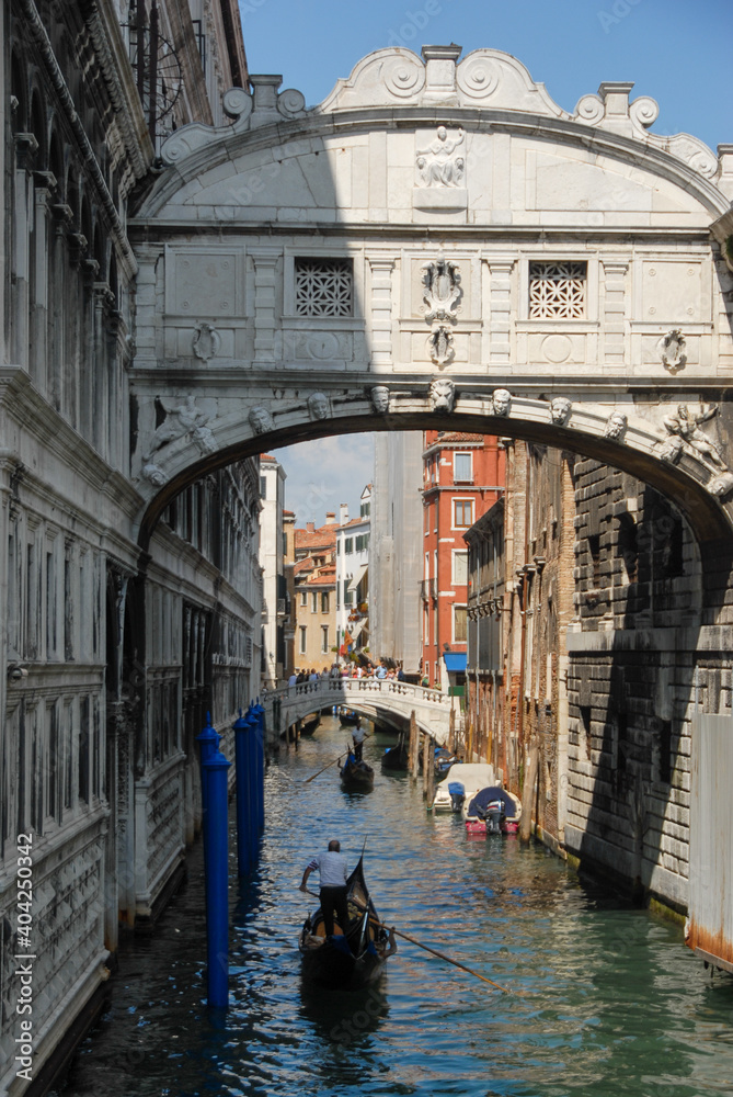 Views traveling in gondola under the Bridge of Sighs through the small canals of Venice Italy