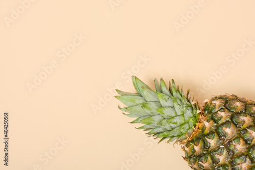 fresh pineapple on beige backgrpund copy space