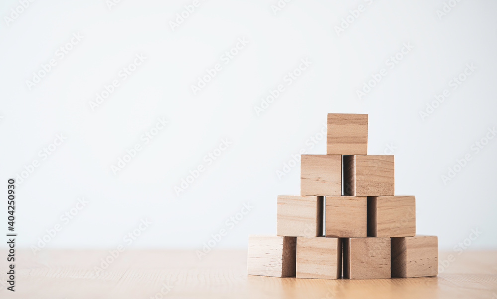 Stacking blank wooden cubes on table with copy space for input wording and infographic icon. Stacking blank wooden cubes on table with copy space for input wording and infographic icon.