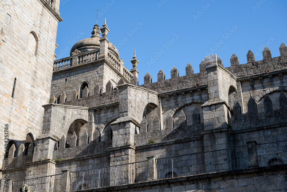 Porto cathedral seen from the inner courtyard. Building made of stone Blue sky.