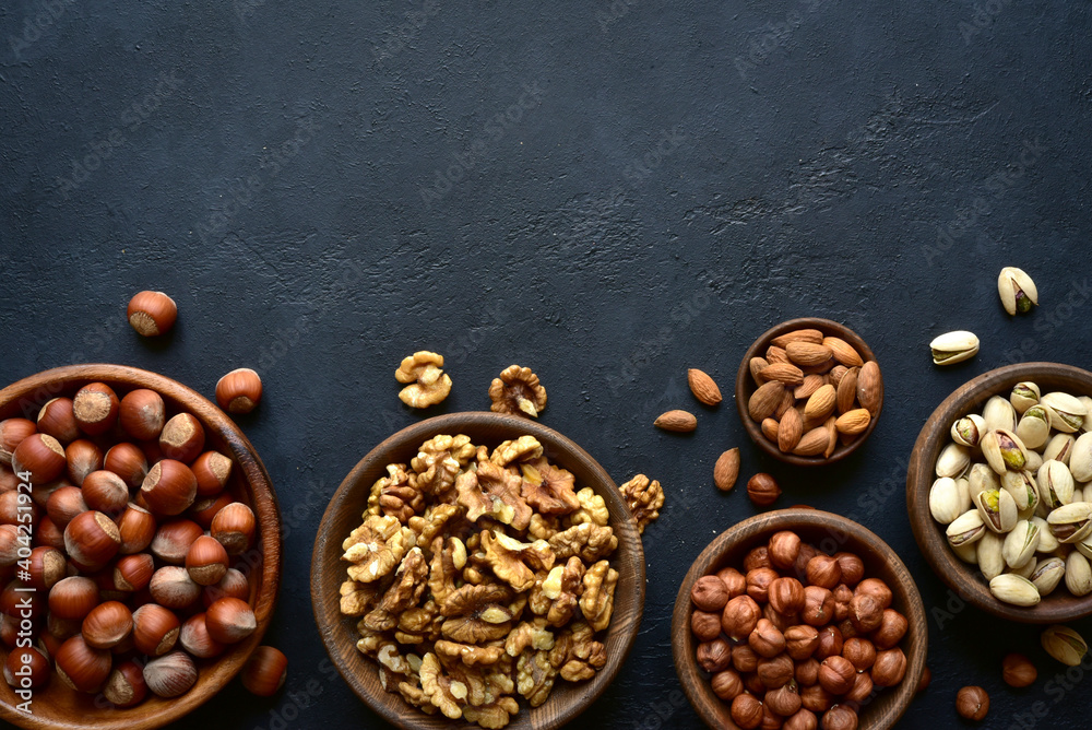 Variety of nuts in a wooden bowl . Top view with copy space. Variety of nuts in a wooden bowl . Top view with copy space.