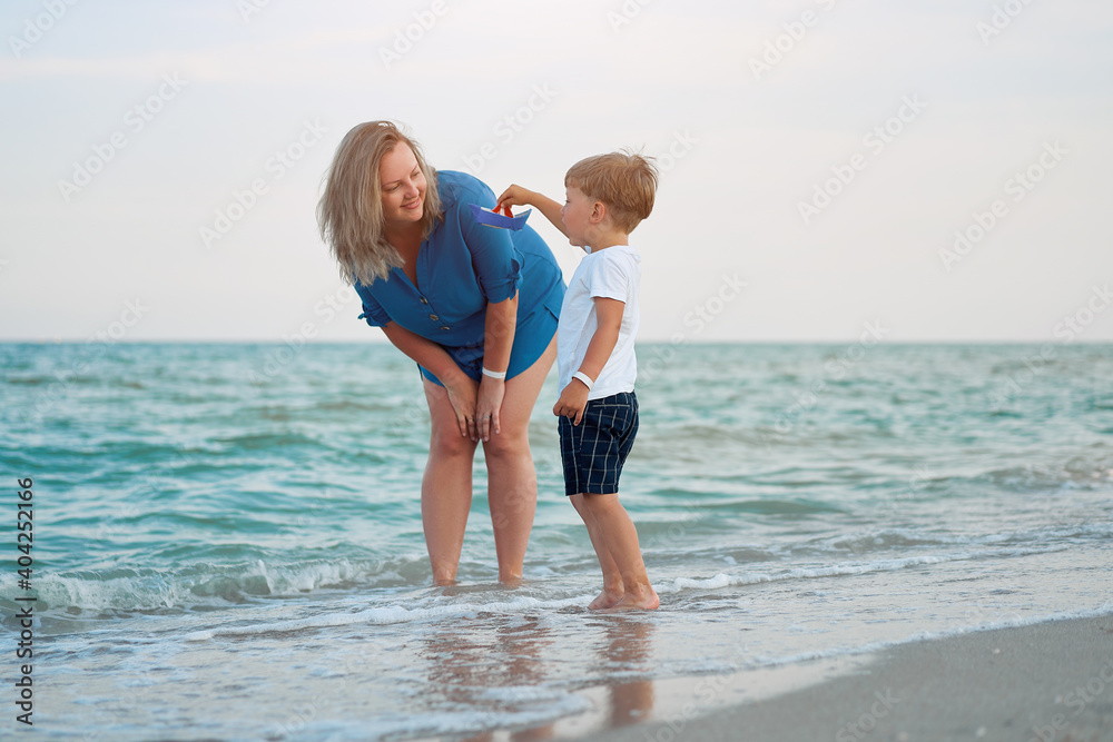 Mother son spending time together sea vacation Young mom child little boy walking beach Mother son spending time together sea vacation Young mom child little boy walking beach