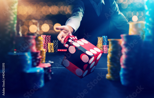 Fototapete Man gambling at the craps table at the casino