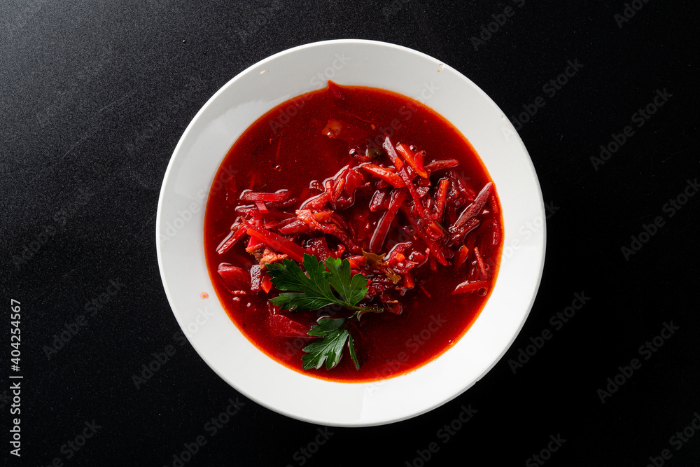 Traditional ukrainian beetroot soup borscht on a minimalistic black background, directly above Traditional ukrainian beetroot soup borscht on a minimalistic black background, directly above