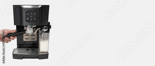 hand inserting the key into the carob coffee maker banner business white background