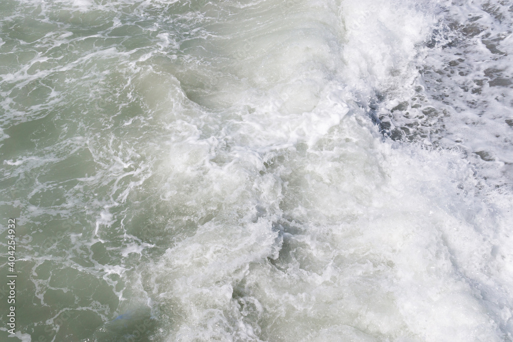 Big waves at open sea. Summer monsoon. White crest of a sea wave. texture background