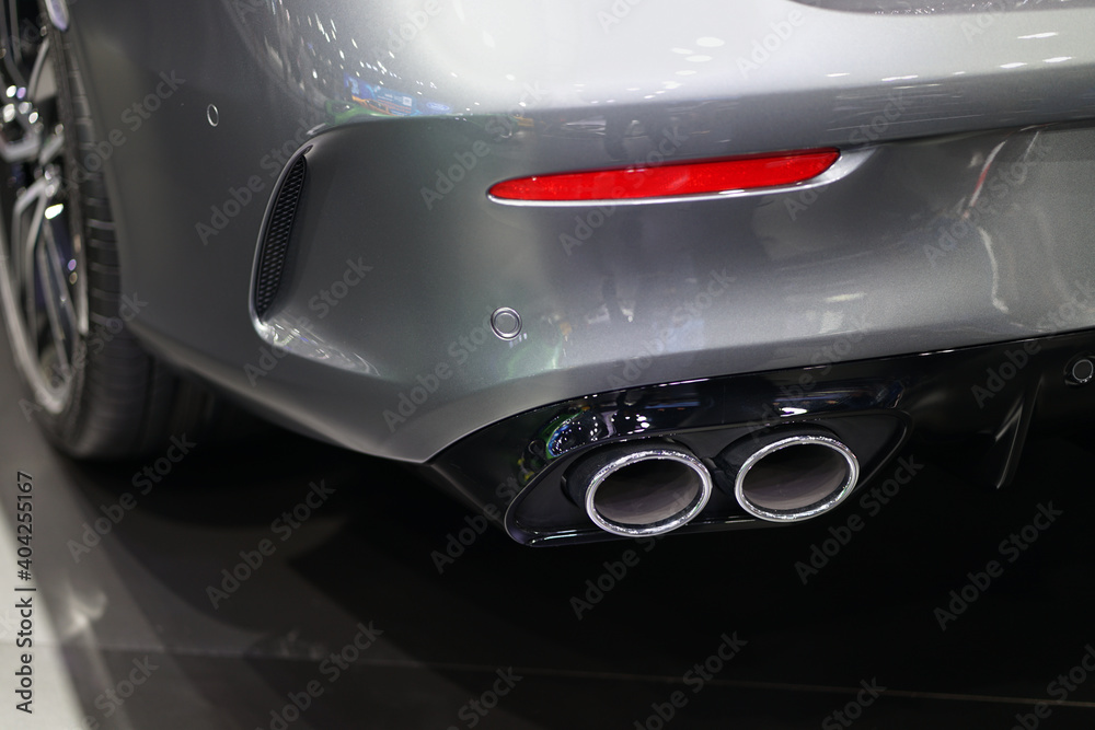 Close up of a car dual exhaust pipe in the sports car.
