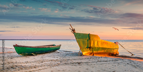 Anchored on sandy beach fishing boats near a small village of fishermen; here...