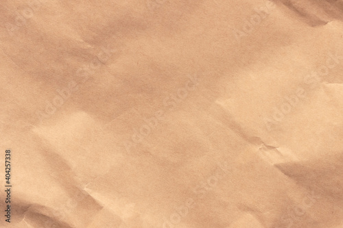 Texture of crumpled light brown craft paper.