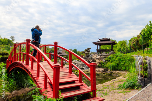 Wallpaper Mural Travel photographer man with professional camera taking photos of Japanese garden Torontodigital.ca