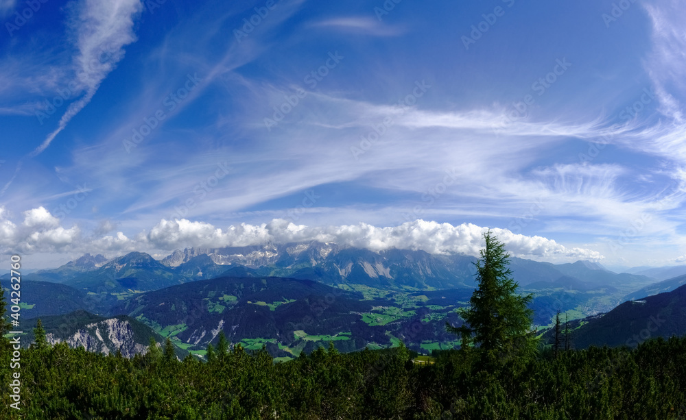 high mountains with white clouds on the blue sky panorama