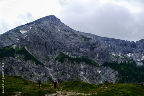 hikers on the path to a steep path from a rocky mountain