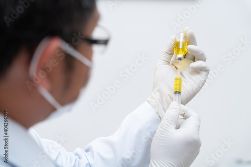 Covid-19 vaccine  Close up of Doctor  nurse  scientist  researcher hand in gloves holding flu  measles  coronavirus vaccine disease preparing  medicine and drug concept.