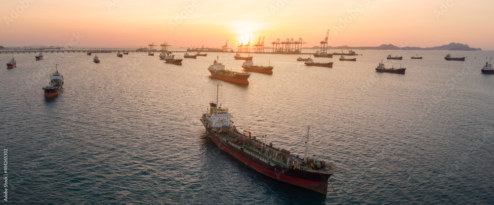 Aerial view of  gas ship  ship for import export dealer and service near international cargo dock sea port at sun set.