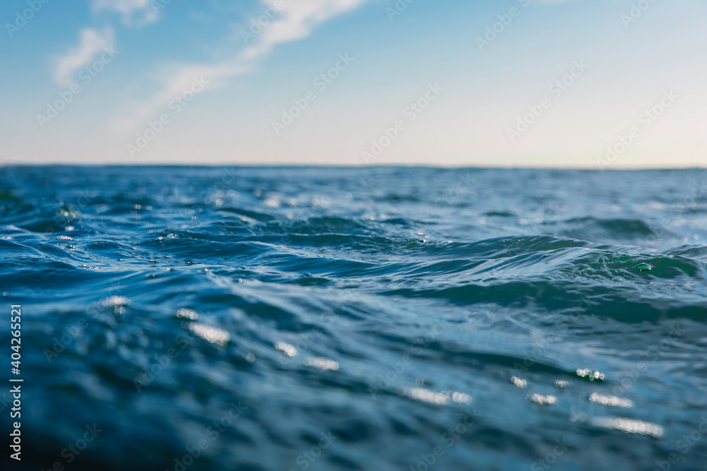Blue waves in sea. Water texture with bokeh Blue waves in sea. Water texture with bokeh