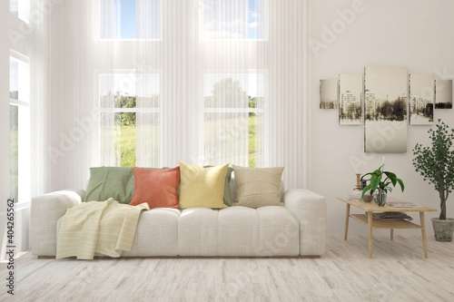 White living room with sofa and summer landscape in window. Scandinavian interior design. 3D illustration