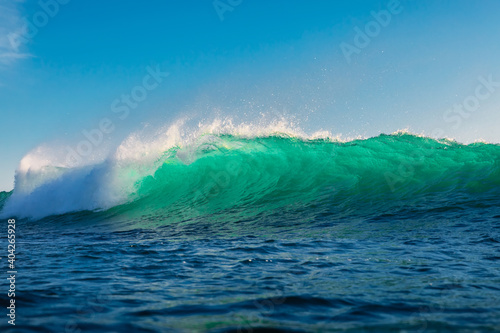 Surfing wave in sea. Breaking turquoise wave sunny day