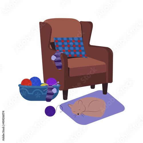 English armchair with a pillow and needlework laying on it. A ball of thread, knitting needles and knitted sock. An isolated element for design