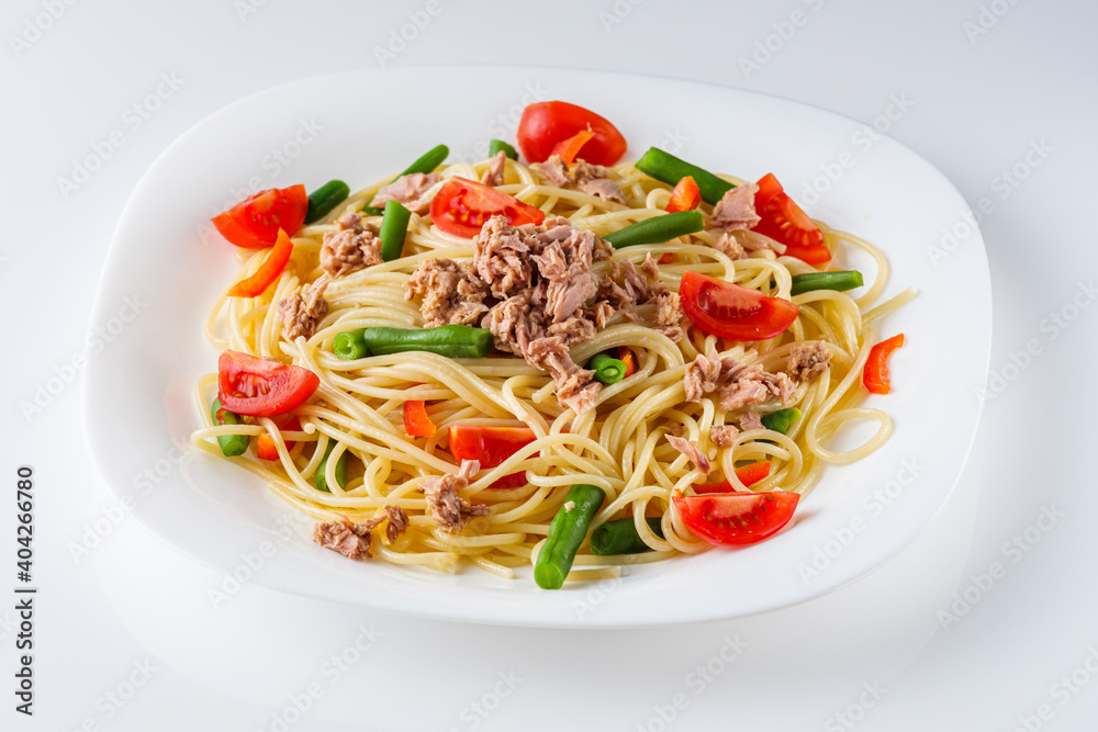 delicious traditional Italian pasta with tuna on a white background delicious traditional Italian pasta with tuna on a white background