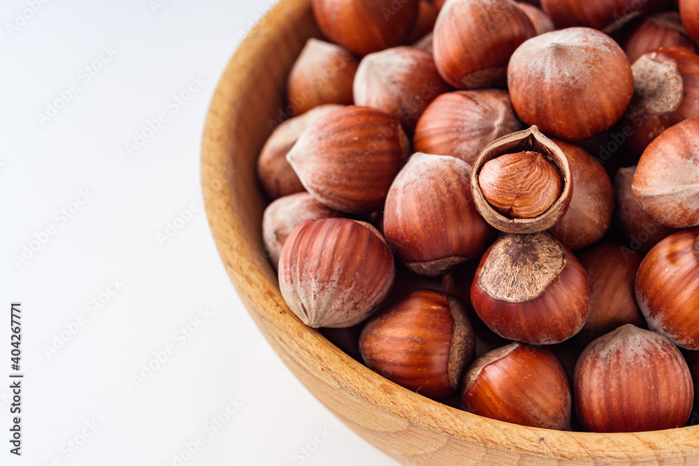 fresh natural hazelnuts on a white acrylic background fresh natural hazelnuts on a white acrylic background