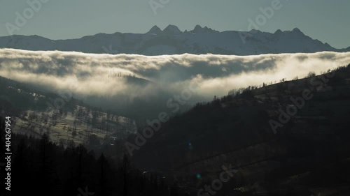Timelapse of clouds between High Tatras and Spisska Magura mountains in windy winter day, Slovakia. Typical slovakian countryside of fields and meadows with Mala Frankova village in valley.