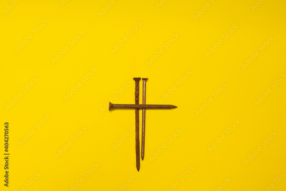 metal rusty nails on a yellow background