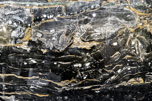 Black quartz stone with white and yellow stripes. Natural quartz background and texture.