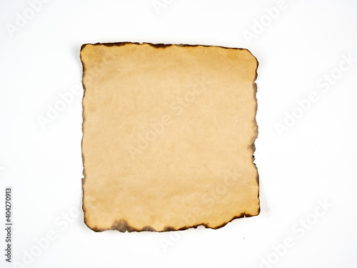 Paper with burnt edges on a white background.