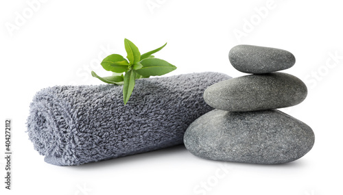 Spa stones  green leaves and towel on white background