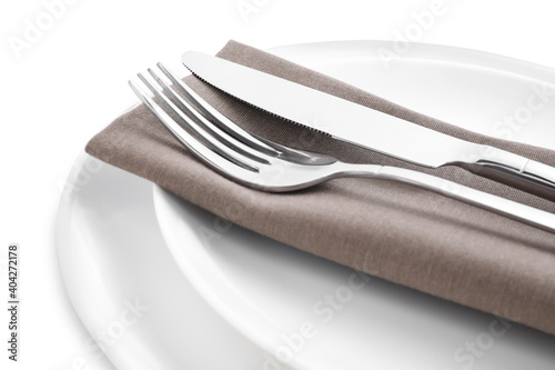 Plates with clean cutlery and napkin isolated on white