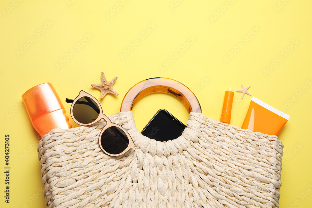 Flat lay composition with sun protection products and beach accessories on yellow background - obrazy, fototapety, plakaty 