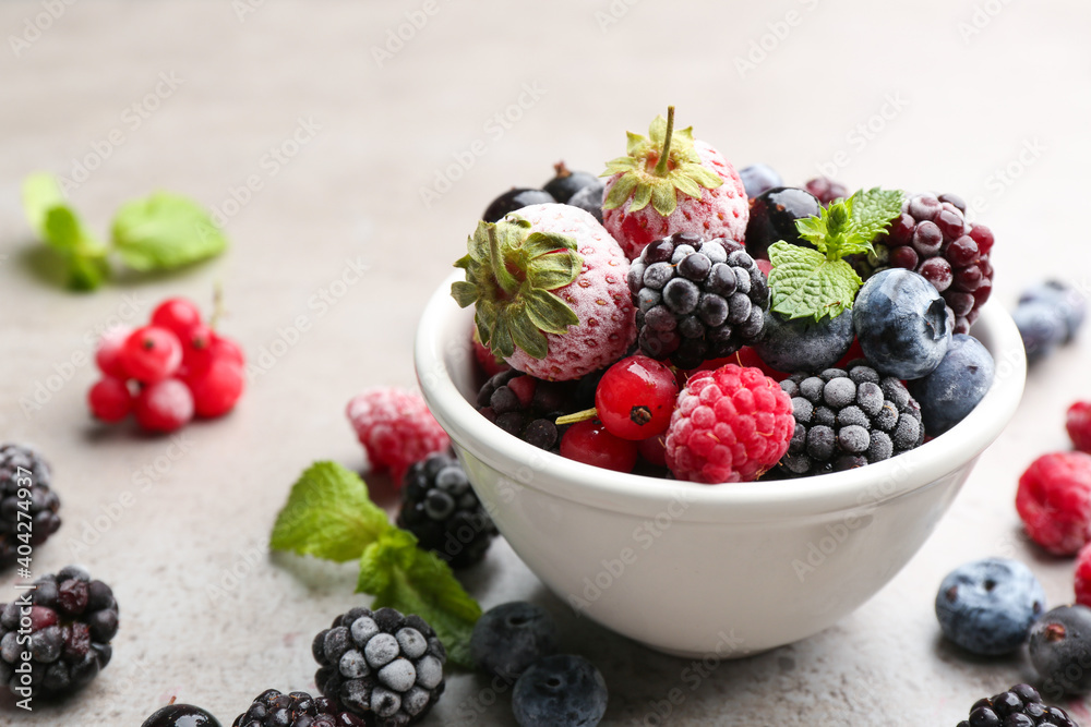 Mix of different frozen berries on grey table, closeup. Space for text Mix of different frozen berries on grey table, closeup. Space for text