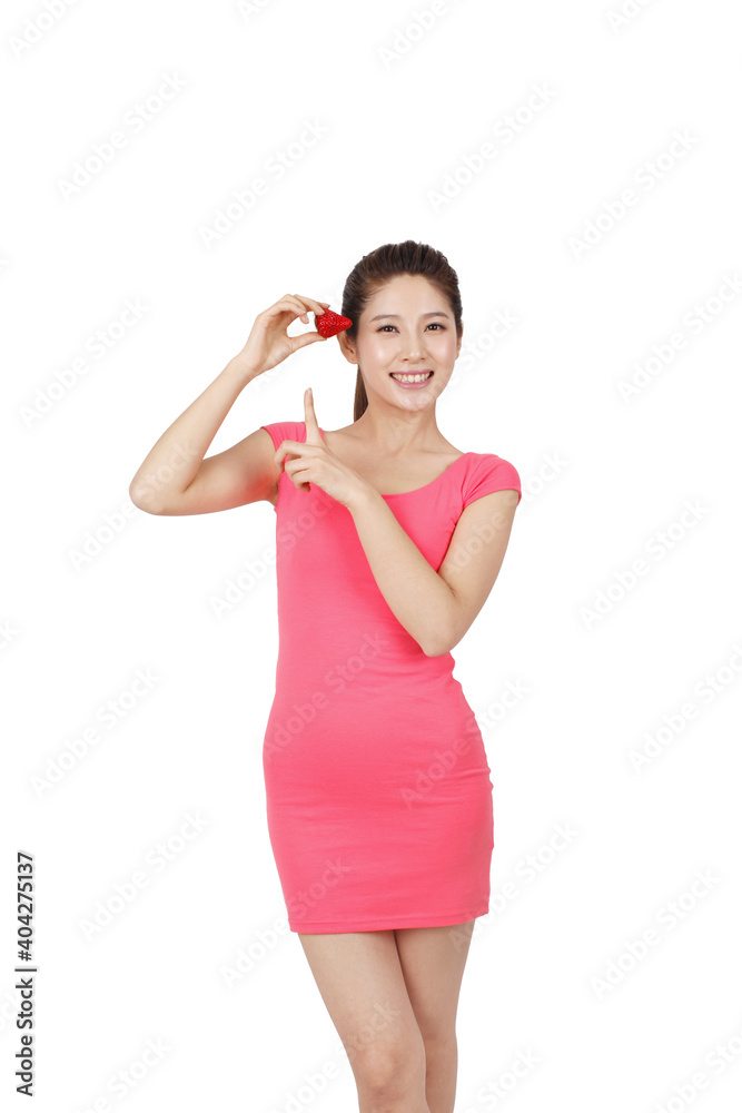 Young woman in pink dress holding strawberry Young woman in pink dress holding strawberry