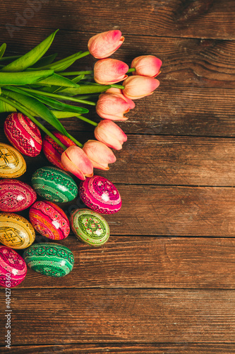 Colorful Easter eggs on wooden background. Happy Easter. Space for text.