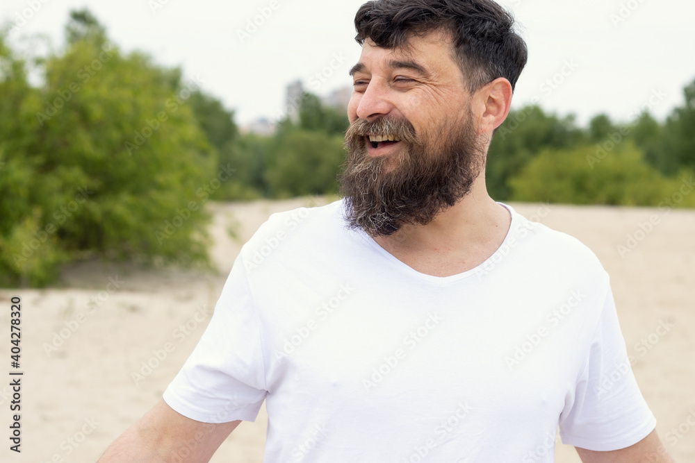 Portrait of a happy bearded man on the background of nature. Portrait of a happy bearded man on the background of nature.