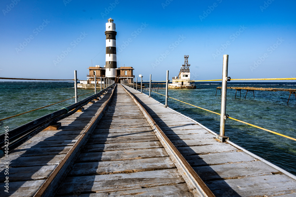 an ancient lighthouse stands in the middle of trade sea routes in the Red Sea