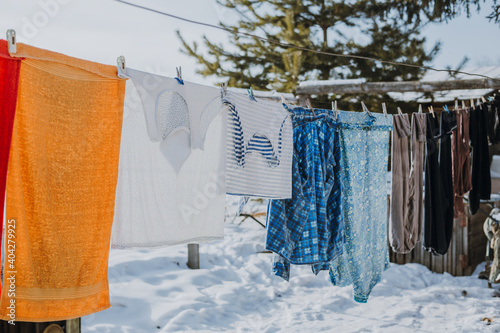 frozen underwear on the street in winter. Snow on the washed linen