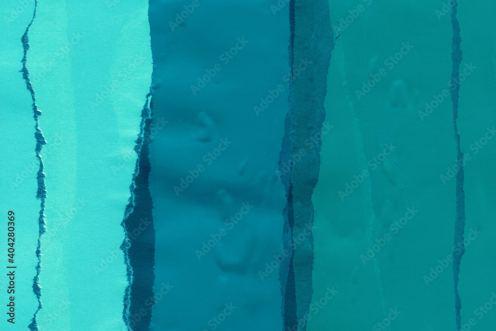 Blue torn paper collage close-up. Texture made from various paper and cardboard parts. Damaged old paper background. Vintage blank wallpaper. Material design backdrop.