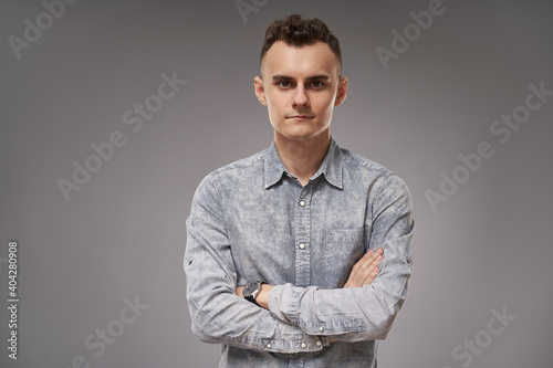 Young businessman on gray background