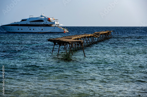 old pier at the lighthouse in the Red Sea on a sunny day against the blue sky