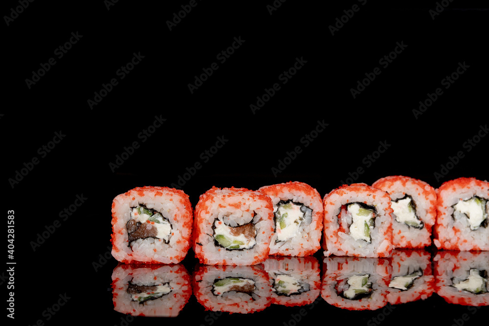 Philadelphia roll with salmon, cheese and cucumber on a black background with reflection. Sushi Philadelphia Philadelphia roll with salmon, cheese and cucumber on a black background with reflection. Sushi Philadelphia
