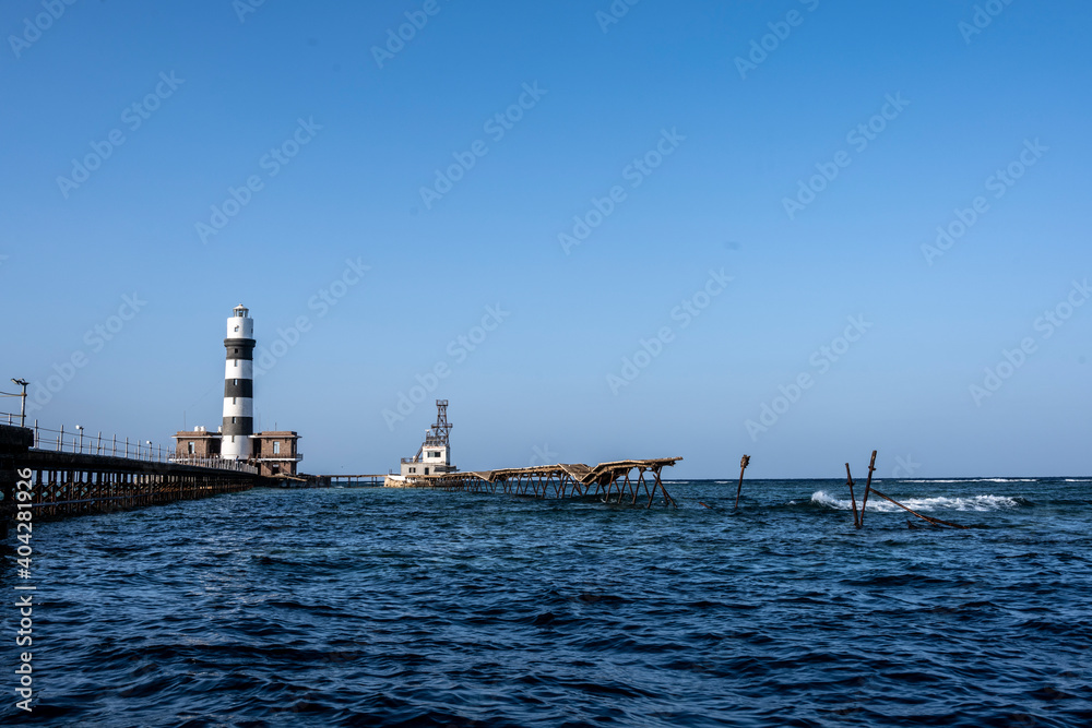 vintage pier and lighthouse in the Red Sea on a sunny day