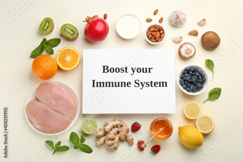 Set of natural products and paper sheet with text Boost Your Immune System on beige background, flat lay