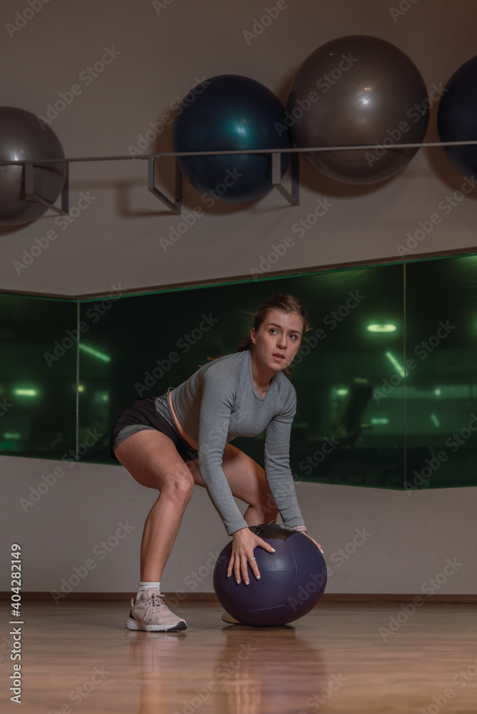 Naklejka premium Fit girl HIIT cardio with medicine ball