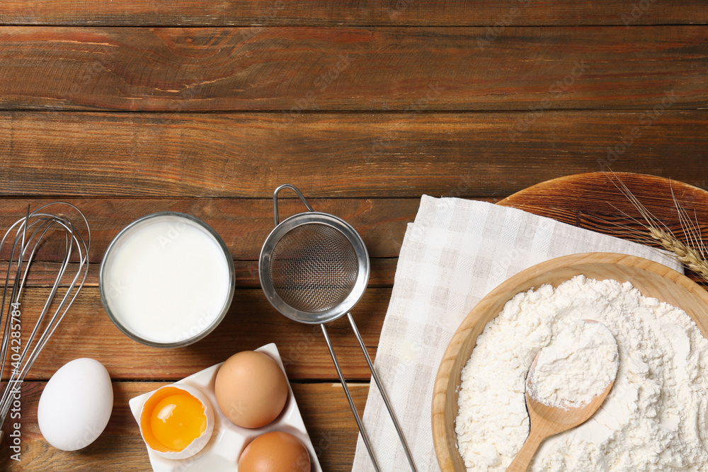 Flat lay composition with dough ingredients on wooden table. Space for text Flat lay composition with dough ingredients on wooden table. Space for text