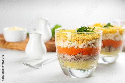Traditional russian salad Mimosa served on white table, space for text
