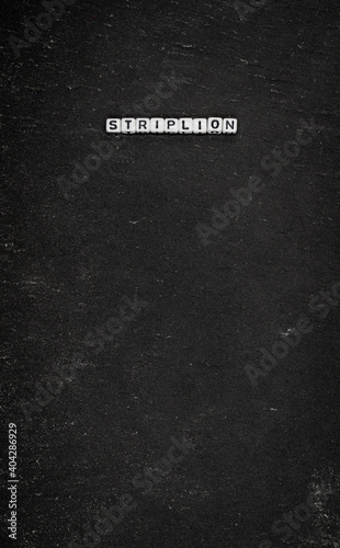 Word striplion on black stone background