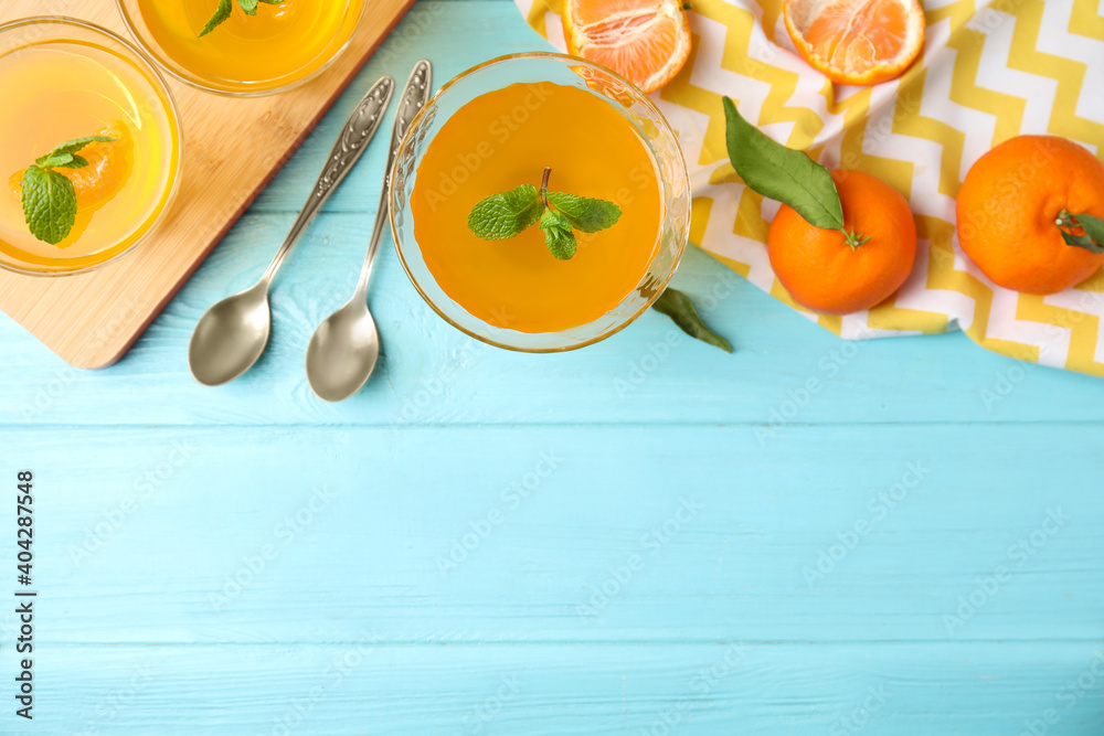 Delicious tangerine jelly and fresh fruits on light blue wooden table, flat lay. Space for text Delicious tangerine jelly and fresh fruits on light blue wooden table, flat lay. Space for text