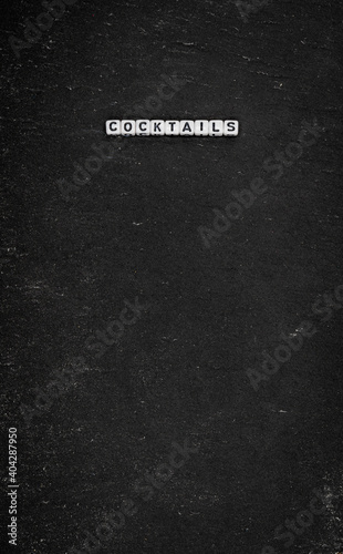 Word cocktails on black stone background